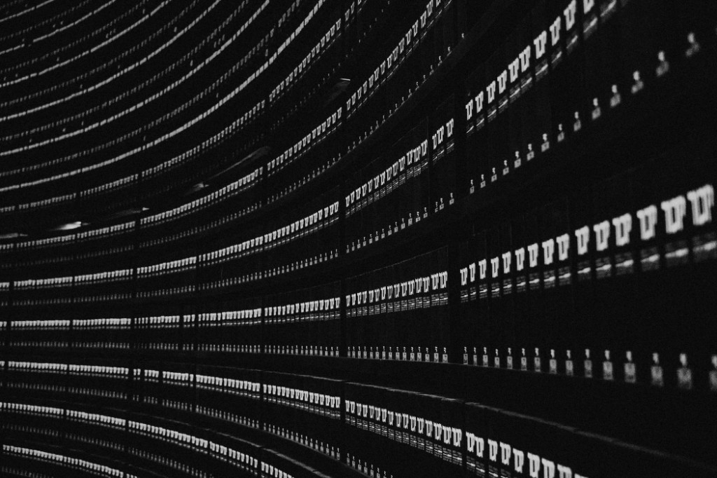 Curved archive shelves of bound records — organized data and records